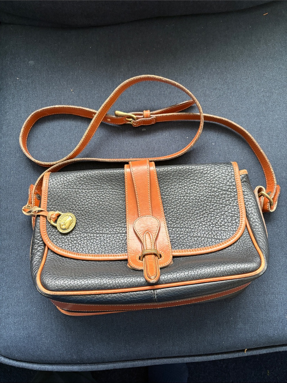 Dooney Bourke Pebbled Black and Tan Leather Crossbody Saddle Bag
